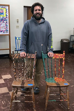FPC Logan church member with chairs for auction